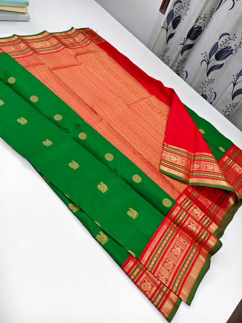Handloom Kanchipuram Silk Saree with a traditional contrast border and buttas.